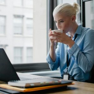 female manager drinking coffee at workplace