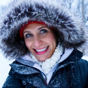 close up photo of woman wearing black zip up parka coat during snow season