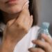 a woman cleaning her face