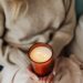 woman holding a burning candle