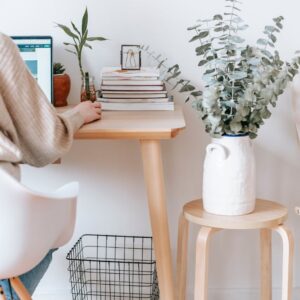 anonymous woman working on laptop in room