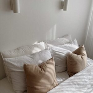 lamps over pillows on bed