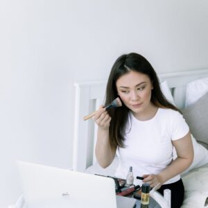 photo of woman sitting on bed